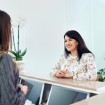 Woman talking to dental receptionist 