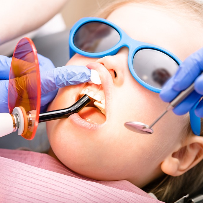 Child receiving dental sealants