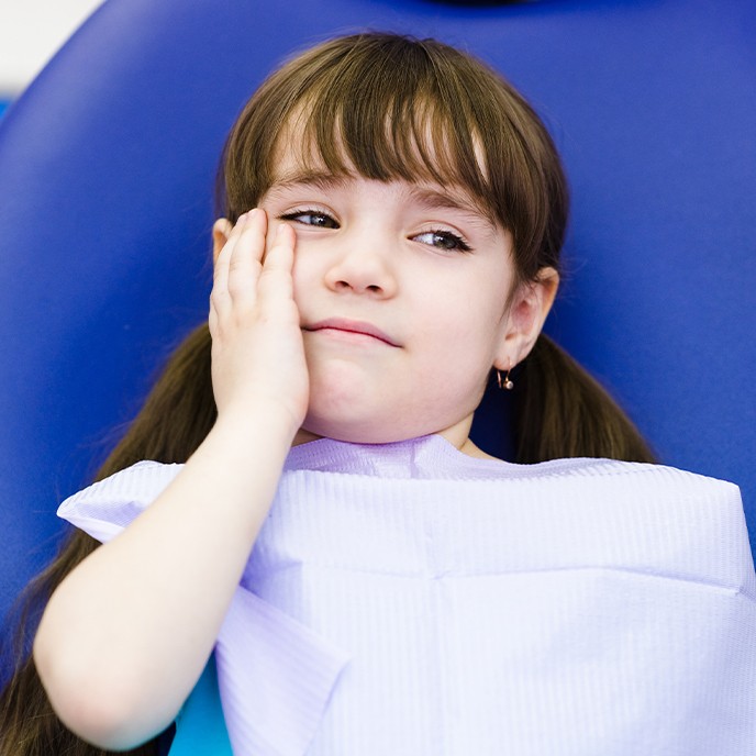 Young girl in pain before pulp therapy