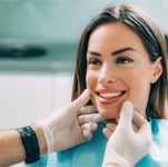 dentist looking at patient’s smile 