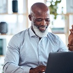 Bearded senior man working on his computer