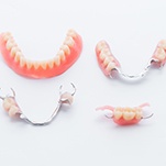 Partial and full dentures on white background