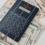 Black calculator on cash
