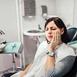 Woman with tooth pain visiting emergency dentist in St Johns, FL