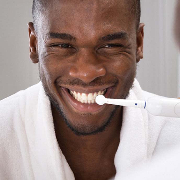 Man brushing teeth to prevent toothache in St. Johns