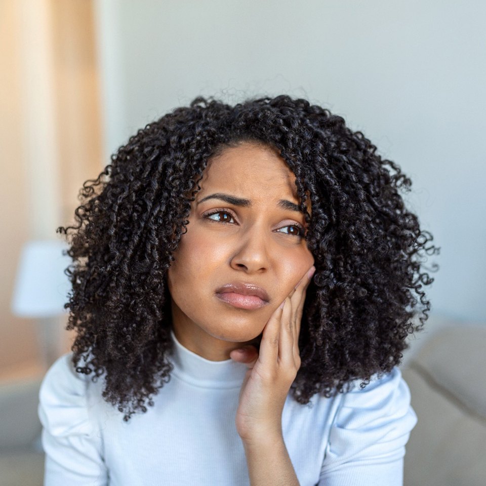 Closeup of patient struggling with jaw pain