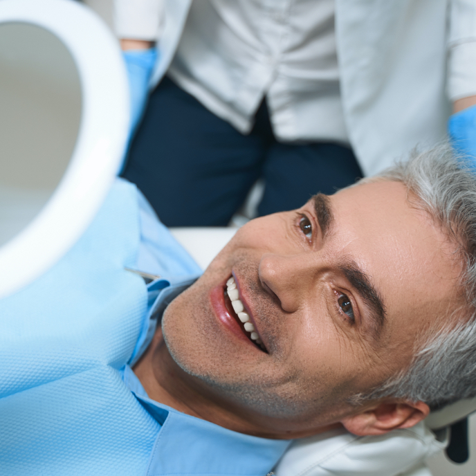 Man sharing flawless smile after dental implant tooth replacement