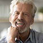 Man smiles with dental implants in St. Johns