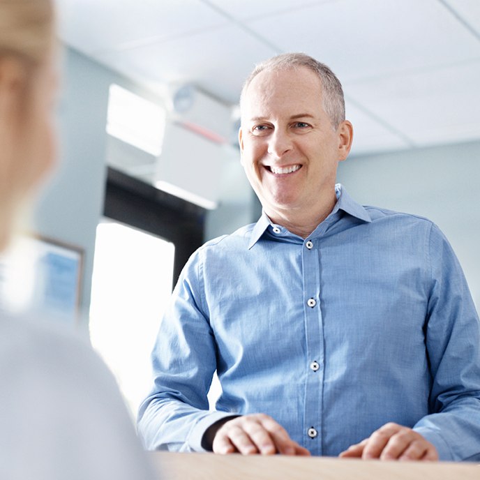 Man turning in dental insurance forms