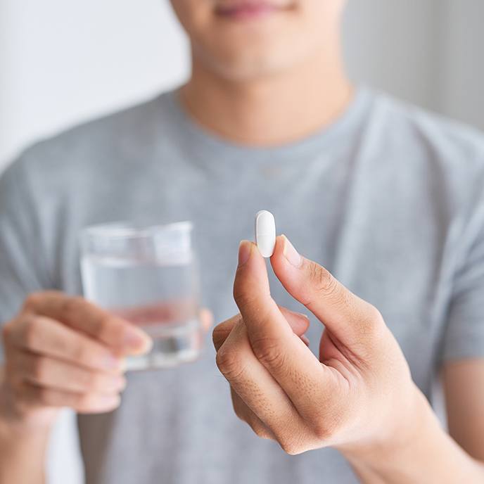 Man holding oral conscious dental sedation pill