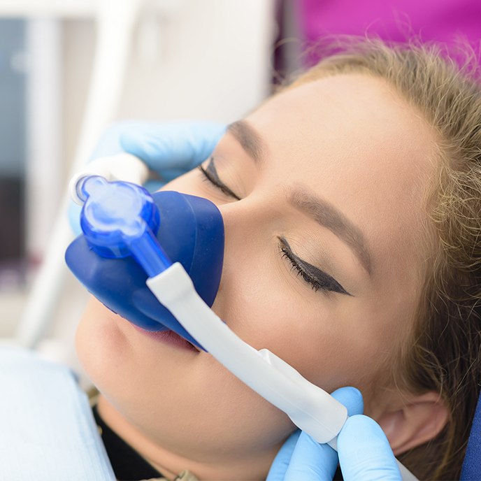 Woman with nitrous oxide dental sedation mask