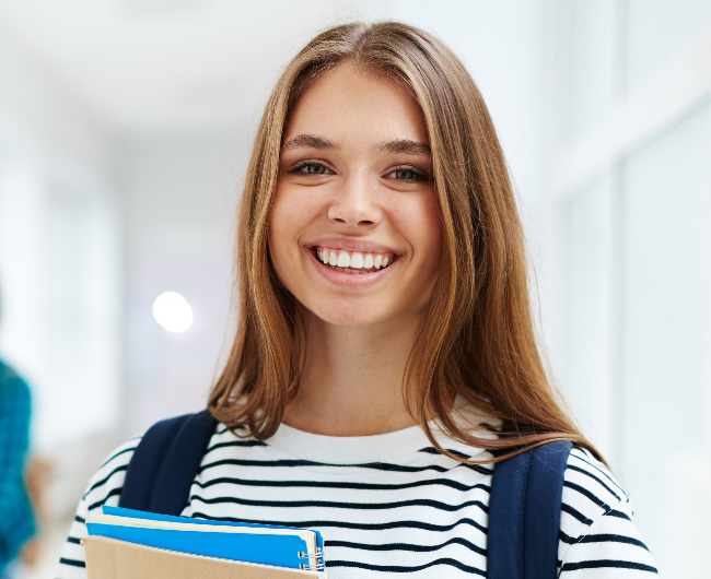 Young woman with healthy smile after preventive dentistry treatment