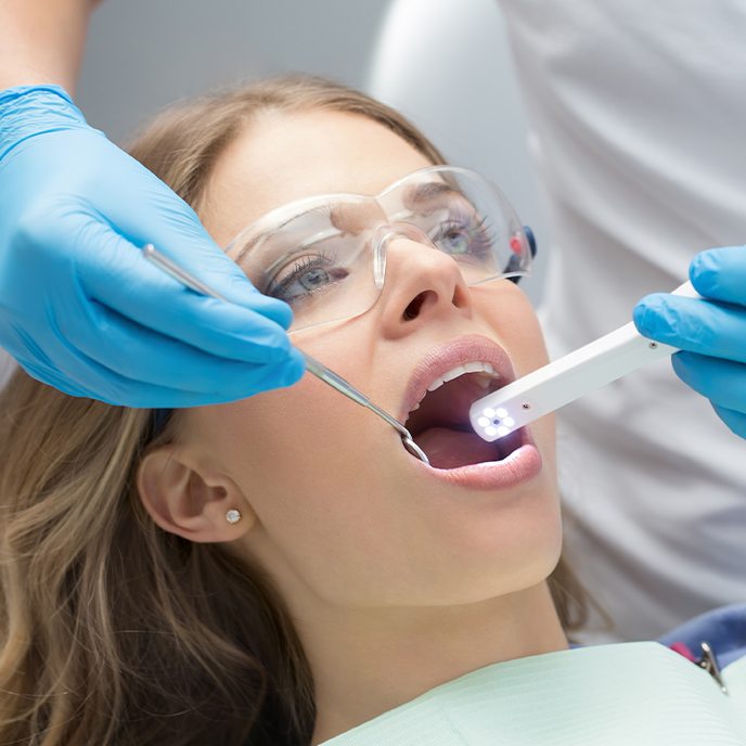 Dentist using intraoral camera to capture smile images