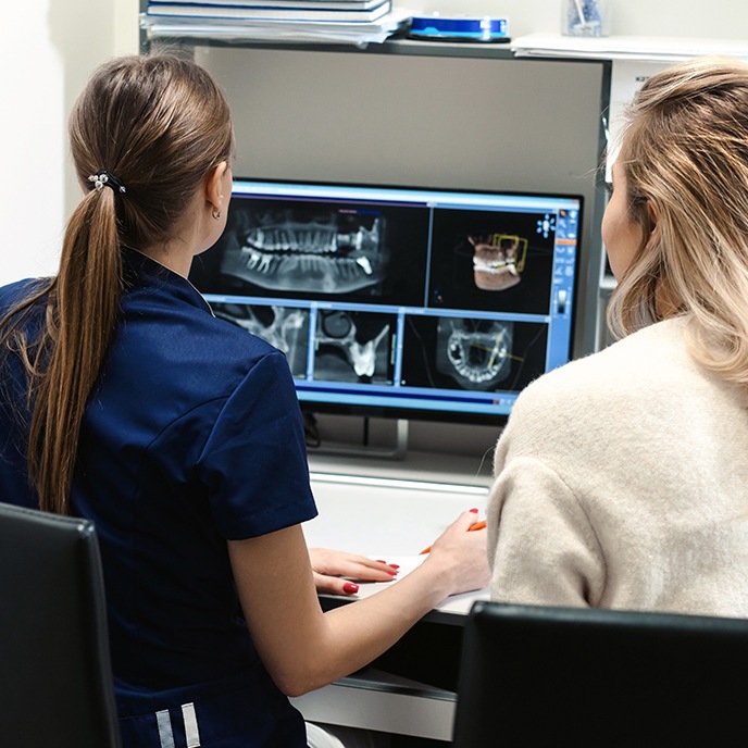 Dental team members looking at all digital x-rays