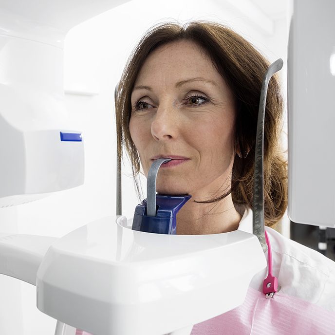 Woman receiving 3 D cone beam image scans