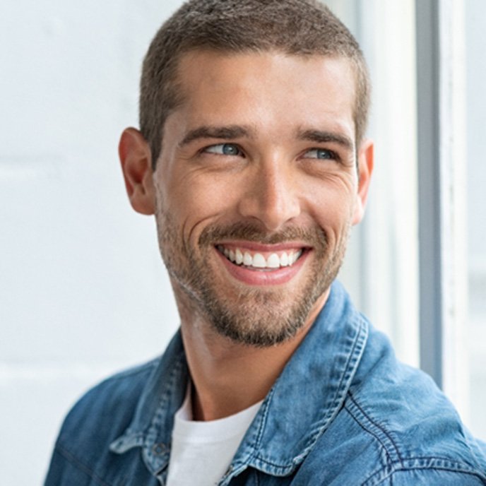 man smiling about the cost of veneers in St. Johns