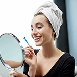 A young female completes a take-home whitening kit in St. Johns