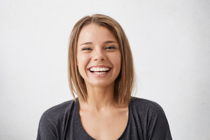 person smiling after getting dental implants