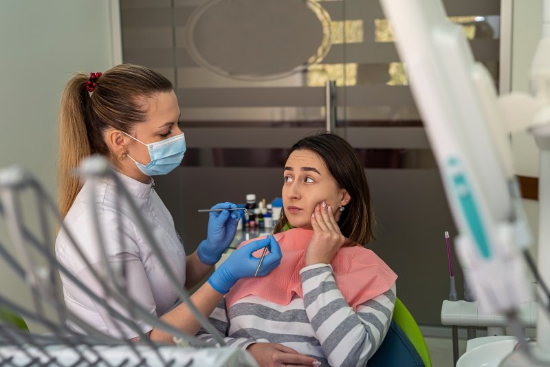 A woman seeing her dentist for dentures treatment