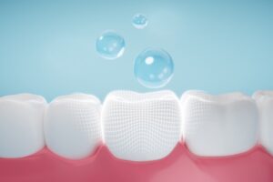 Fluoride treatment representation with bubbles hovering above teeth. 